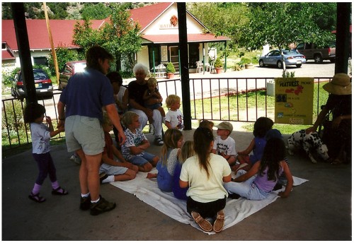 Carol Meine talks to Alice Rodgers, volunteer, during a Creature Features session in the village park.